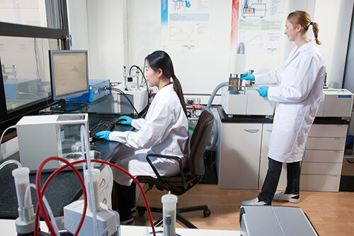 Panacol employees check the quality of an adhesive on equipment