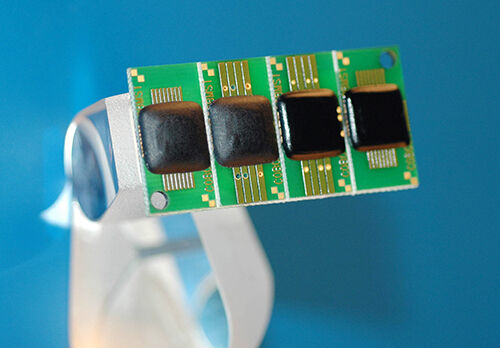 four electronic components with a Glop Top potting compound of black adhesive