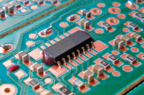 An SMD on a PCB secured with adhesive