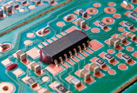 An SMD on a PCB secured with adhesive